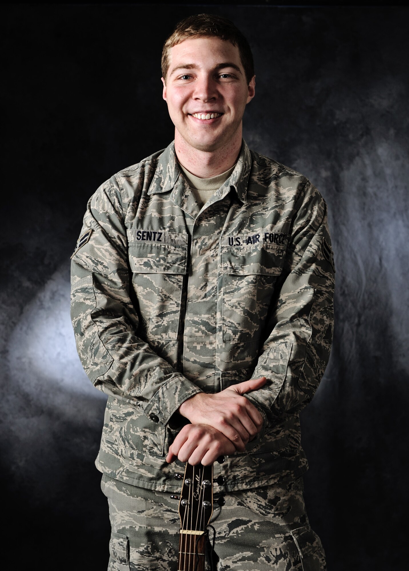 Airman 1st Class Timothy Sentz, 375th Communications Squadron client systems technician, smiles as he gets his photo taken. Sentz was recently notified of his selection to be part of the 2012 Tops in Blue tour.(U.S. Air Force photo/Staff Sgt. Ryan Crane)