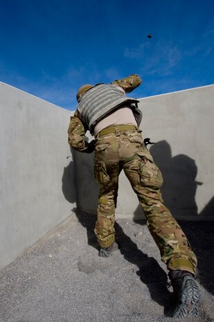 A U.S. Air Force pararescueman, 58th Rescue Squadron, throws a fragmentation grenade during grenade training Jan. 27, 2012, on the Nevada Test and Training Range.  Pararescuemen are trained to provide emergency medical treatment in adverse terrain and conditions, in combat or peacetime.  (U.S. Air Force photo by Staff Sgt. William P. Coleman)
  

