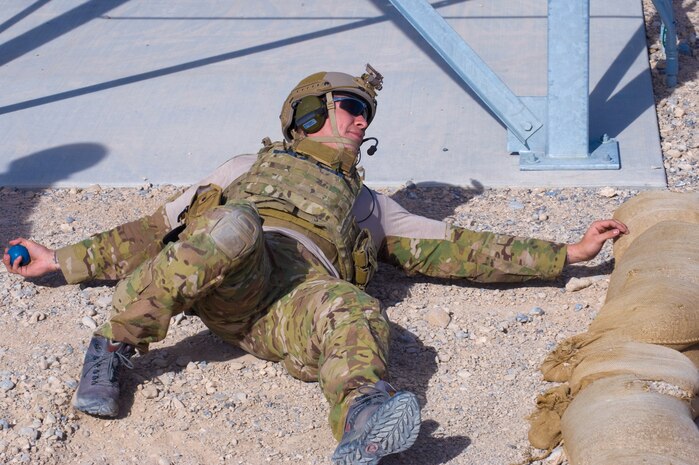 A U.S. Air Force pararescueman, 58th Rescue Squadron, throws a practice grenade from the reverse prone position during grenade training Jan. 27, 2012, on the Nevada Test and Training Range.  Pararescuemen are trained to provide emergency medical treatment in adverse terrain and conditions, in combat or peacetime.  (U.S. Air Force photo by Staff Sgt. William P. Coleman)
  

