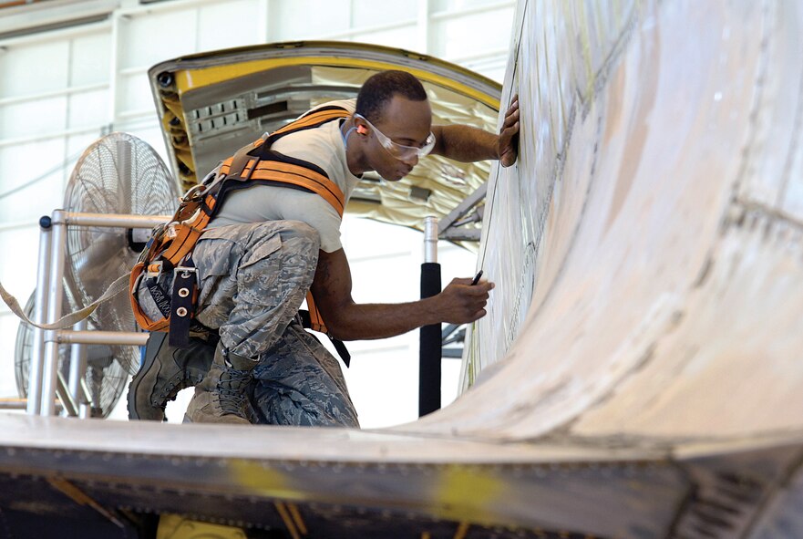McConnell Air Force Base, Kan., KC-135 flying crew chief Staff Sgt. Carlos Mitchell, 22nd Aircraft Maintenance Squadron, inspects the crew’s tanker during depot maintenance here.  Tanker crews and Tinker maintainers of the 564th Aircraft Maintenance Squadron work together — under Team Spirit, a Tinker program that speeds production time and fosters better communications between Tinker maintainers and their customers — to find and quickly fix discrepancies. (Air Force photo by Margo Wright)