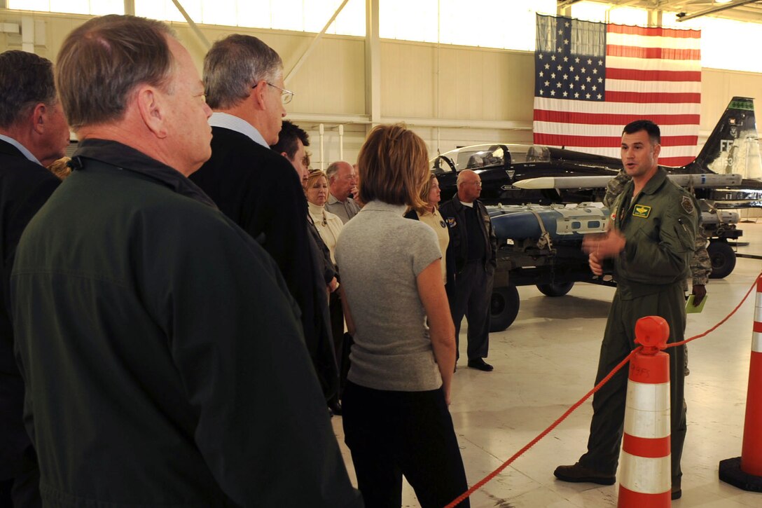 U.S. Air Force Lt. Col. Pete Fesler, 1st Operations Group deputy commander, talks about the F-22 Raptor’s maneuvering superiority during the Air Force Chief of Staff Civic Leader Tour at Langley Air Force Base, Va., Feb. 1, 2012. F-22s host advanced technology enabling pilots to gain a decisive combat edge over other fighter aircraft. (U.S. Air Force photo by Staff Sgt. Jeff Nevison/Released)