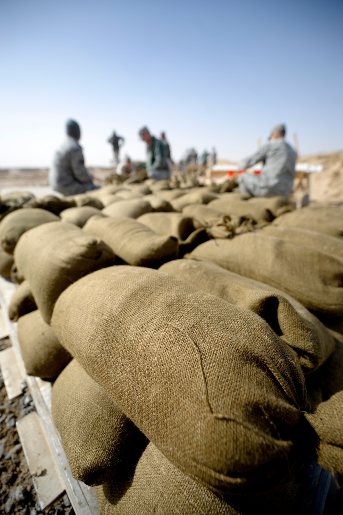 Members of the 332nd Expeditionary Civil Engineer Squadron, participate in a sandbag build at an undisclosed location in Southwest Asia, Feb. 3, 2012. The sand bags will be used to add extra protection to safety bunkers throughout the base. (U.S. Air Force photo by Staff Sgt. Joshua J. Garcia/Released)