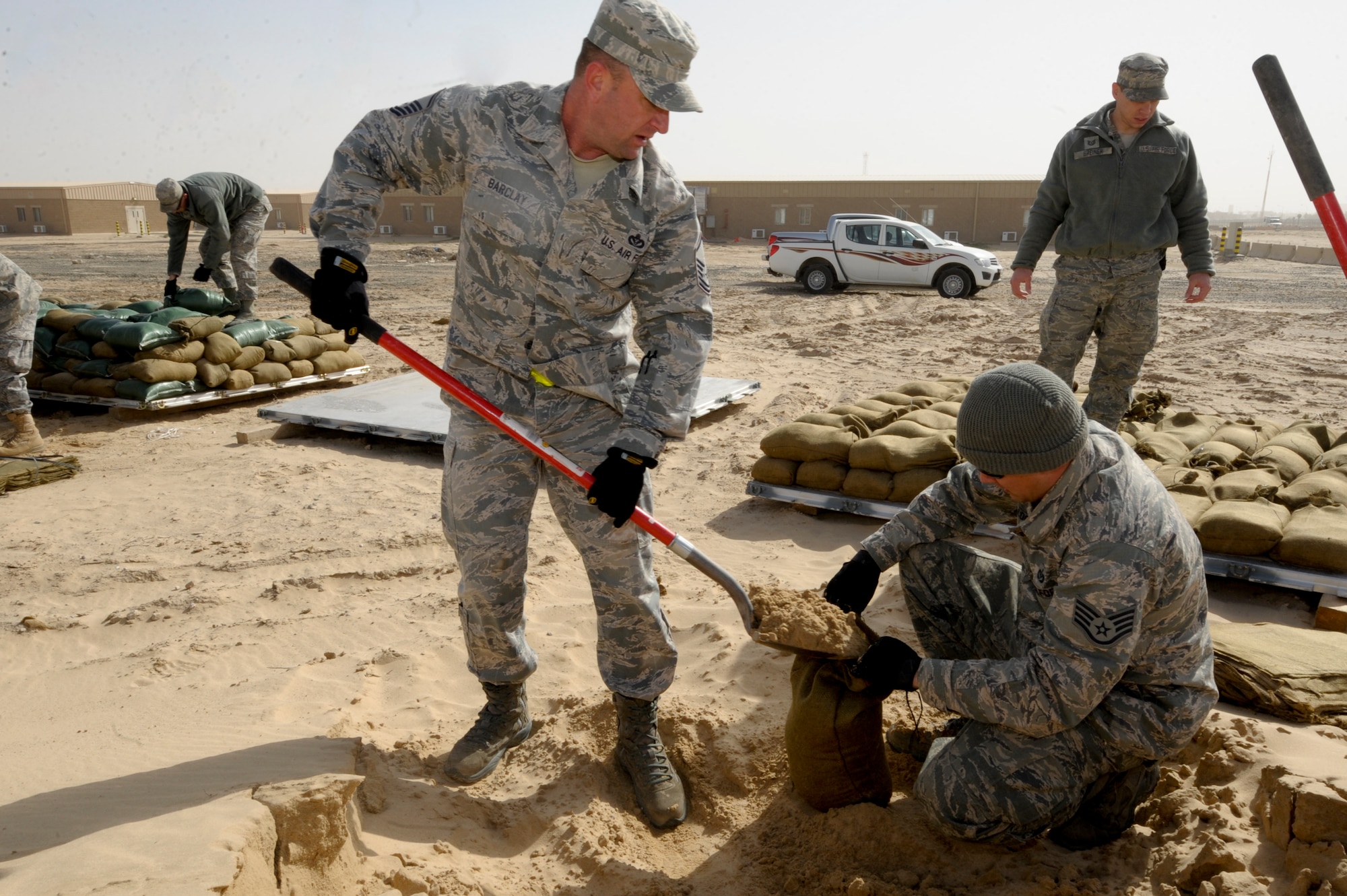 Master Sgt. Curtis Barclay, and Staff Sgt. Christopher Looney, 332nd Expeditionary Civil Engineer Squadron members, fill sandbags at an undisclosed location in Southwest Asia, Feb. 3, 2012. Multiple shops from the 332nd ECES came together to build 2,500 bags during the day. Barclay is deployed from Altus Air Force Base, Okla., and is a native of Eagle River, Alaska. Looney is deployed from Mountain Home Air Force Base, Idaho, and is a native of Duncan, Okla. (U.S. Air Force photo by Staff Sgt. Joshua J. Garcia/Released)