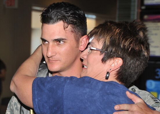 Senior Airman Adam Schatzinger, 377th Security Forces Squadron, gets a big hug Jan. 26 from his mother, Gloria, at the Albuquerque International Sunport following a six-month deployment to Qatar. Schatzinger was one of 13 Airmen to return home. (Photo by Todd Berenger)