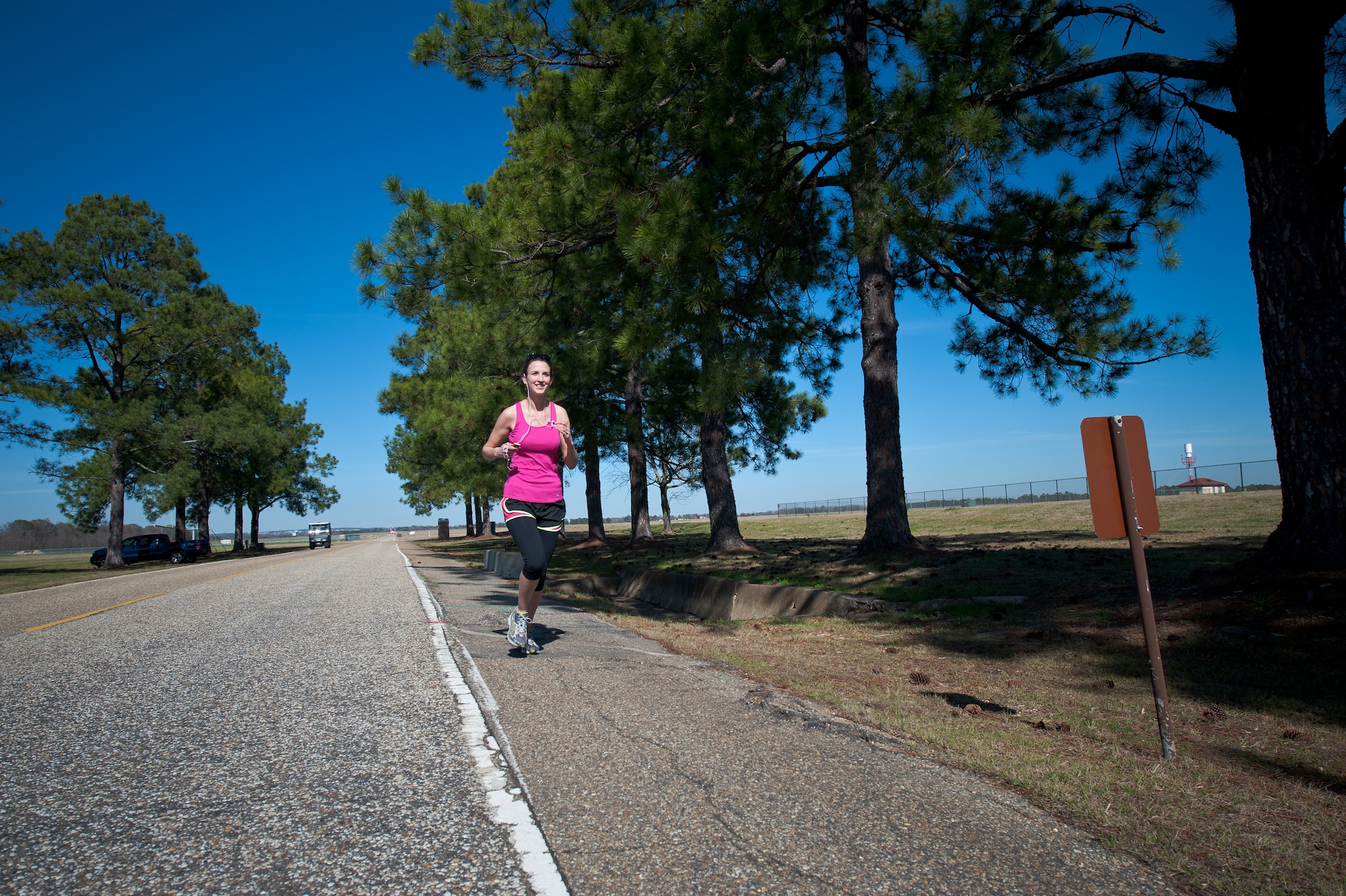 Carrie Springer, librarian with the Muir S. Fairchild Research Information Center, is one of many runners on base who run along the designated running path on March Road. The safety office advises runners to heed safety warnings posted along the running route. Runners should be cautious about sharing the road with vehicles and wear reflective gear if running at or after dawn or dusk. (Air Force photo/Melanie Rodgers Cox)