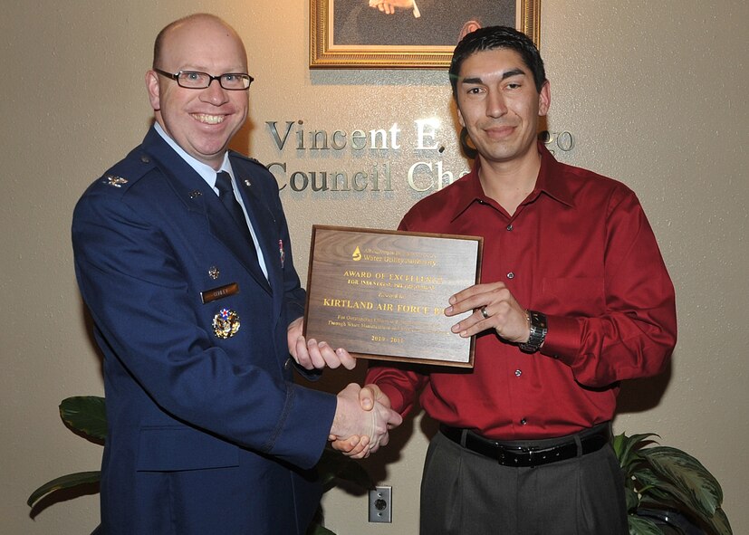 Col. Donald Conley, 377th Mission Support Group commander, left, and Christopher Segura, 377th Civil Engineer Division Environmental Water Quality program manager, right, accepted an award on behalf of the base from the Albuquerque/Bernalillo County Water Utility Authority during a ceremony Jan. 25 at the Albuquerque/Bernalillo County Government Center.
