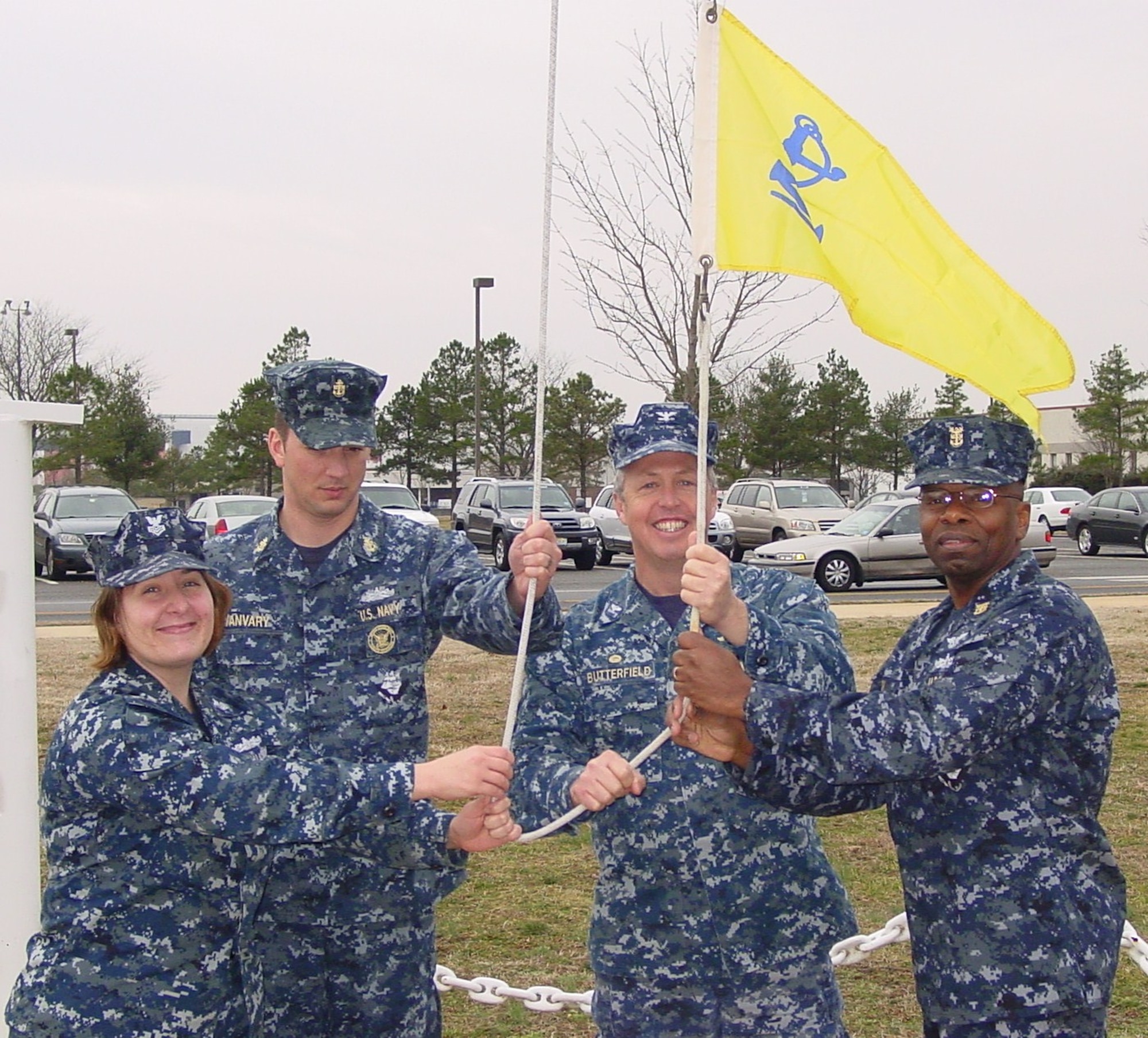 (From left to right) Petty Officer Brandi Jasso, Chief Petty Officer David Yanvary, Navy Capt. Andrew Butterfield and Command Master Chief Herbert Kelton hoists up the Golden Anchor banner Jan. 17 here. Naval Support Activity-Lakehurst was awarded the Commander Navy Installations Command Retention Excellence Award, which is also known as the “Golden Anchor,” for achieving the goals set forth by the Chief of Naval Operations.  (U.S Navy photo by Petty Officer Second Class Darren Grant/Released)