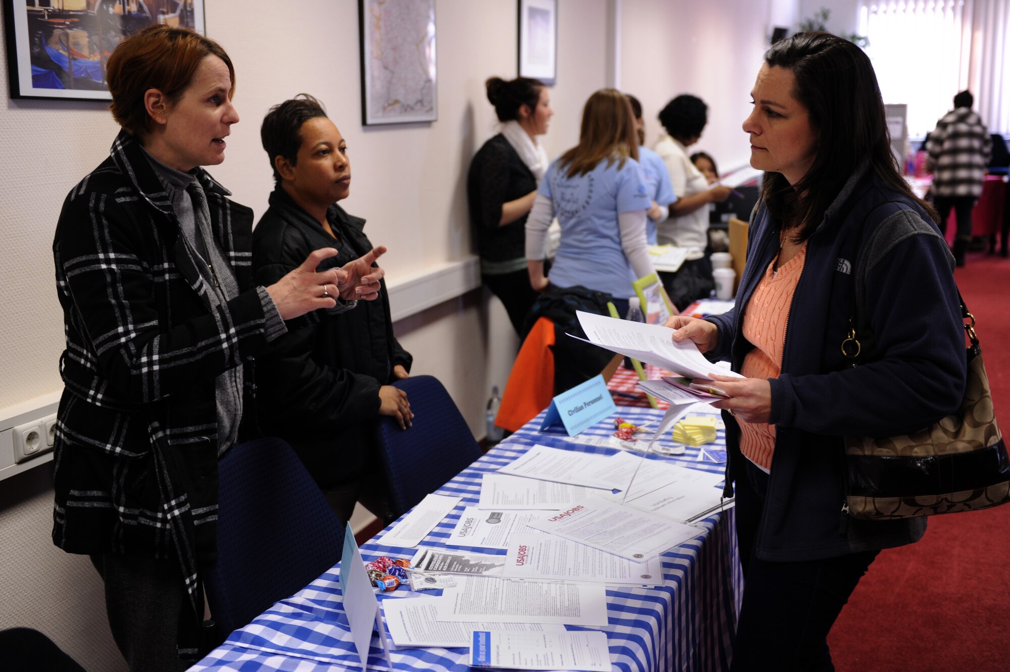 SPANGDAHLEM AIR BASE, Germany – Sandra Sharp, 52nd Force Support Squadron resources specialist, talks with Nikki Urenda about the availability and process of getting a job on base as the spouse of an active-duty service member during the “New Year New You” info and job fair at the Eifel Conference Center here Jan 31. More than 20 organizations from on and off base attended the fair sponsored by the 52nd Force Support Squadron Airman and Family Readiness Center and the Volunteer Advisory Committee. The fair was held to help the base populace learn about community activities and get involved with organizations to work toward their New Year’s resolutions. (U.S. Air Force photo/Airman 1st Class Matthew B. Fredericks)