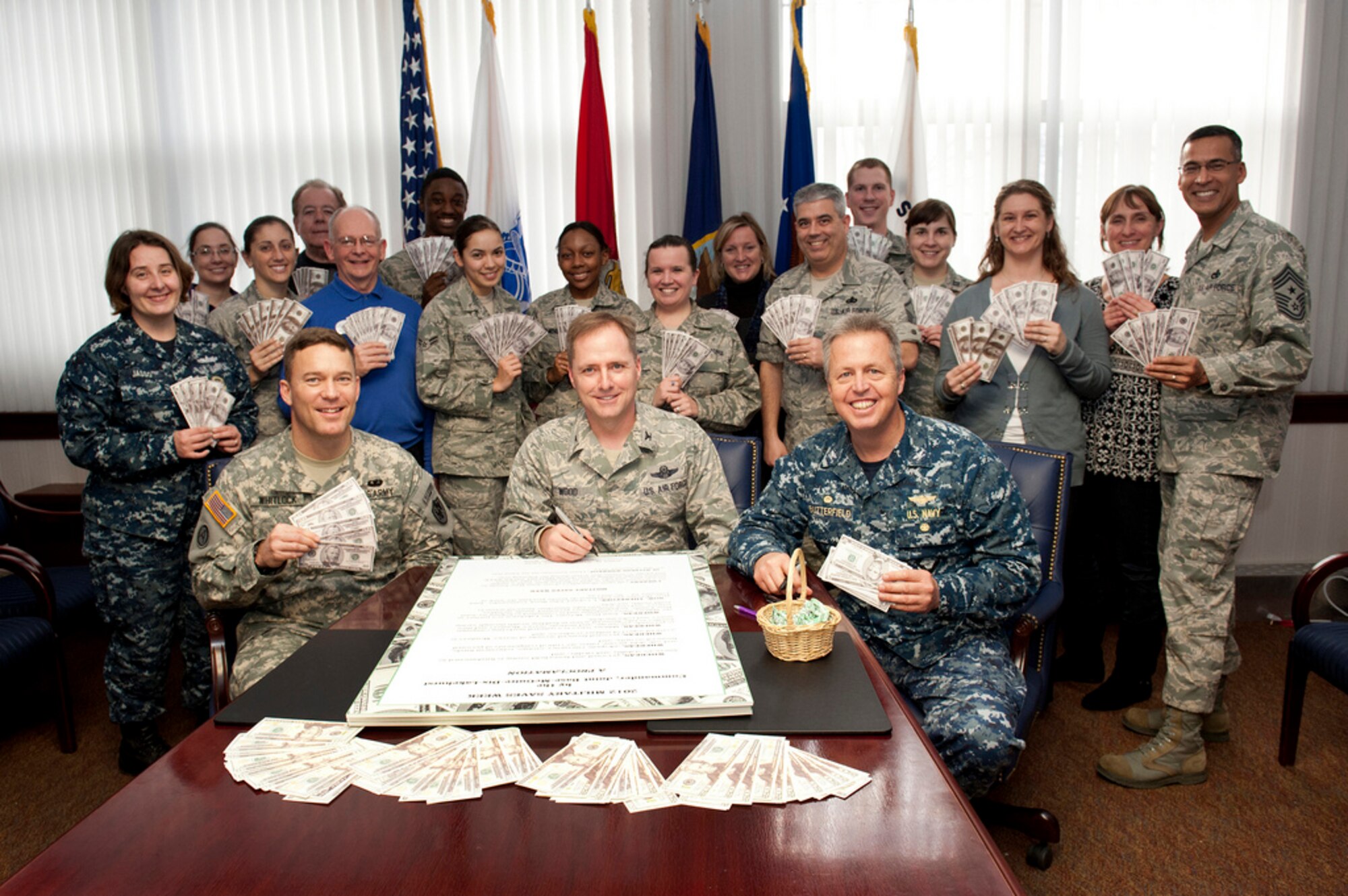 Col. John Wood, Joint Base McGuire-Dix-Lakehurst commander, signs a proclamation kicking-off Military Saves Week campaign Jan. 27 here. Military Saves is a national campaign geared toward motivating and encouraging military families to save money monthly and convincing leaders and organizations to promote automatic savings programs. (U.S. Air Force photo by Russell Meseroll/Released)
