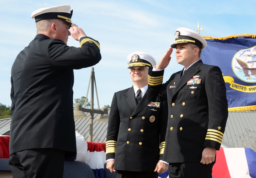 Admiral Kirkland Donald (center) observes as Capt. Jon Fahs (right) assumes command of Navy Nuclear Power Training Command from Capt. Thomas Bailey, Jan. 27 at Joint Base Charleston Weapons Station. Donald is the Naval Reactors Director.  (U.S. Air Force photo/Airman 1st Class Tom Brading)