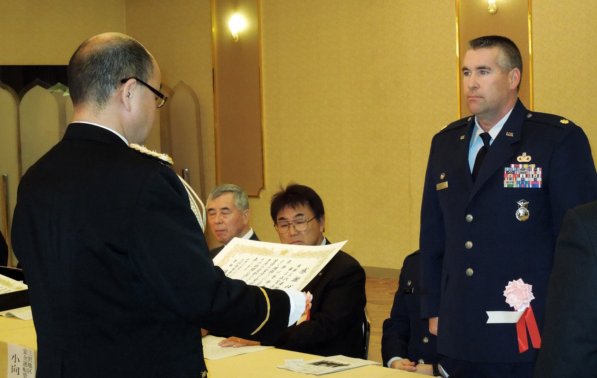 MISAWA CITY, Japan -- Chief of Misawa City Police Station, Shigeki Sasaki, presents Maj. Leo Martin, 35th Security Forces Squadron commander, a certificate of appreciation at the Hotel Grand Hill, Jan. 26. Martin accepted the certificate on behalf of the squadron for their effort in assisting the Japanese National Police during the past year. (courtesy photo) 
