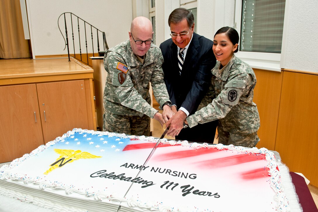 U.S Army Col. Jeffrey Ashley, left, U.S. Defense Secretary Leon E. Panetta and U.S. Army 2nd Lt. Analise Medina cut a birthday cake honoring the 111th birthday of the U.S. Army Nurses Corps at Landstuhl Regional Medical Center, Germany, Feb. 3, 2012. Panetta traveled to Ramstein Air Base and Landstuhl to visit patients, and thank service members directly involved with the transportation and care of wounded warriors. DOD photo by U.S. Navy Petty Officer 1st Class Chad J. McNeeley