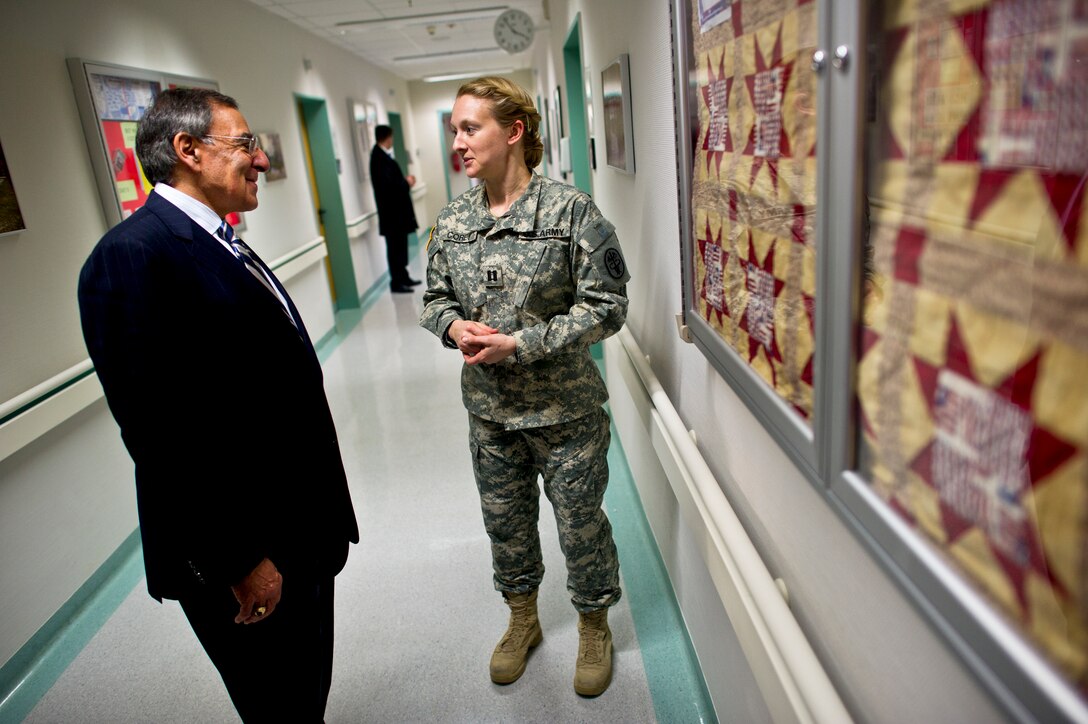 U.S. Defense Secretary Leon E. Panetta speaks with U.S. Army Capt. Jennifer Corey a physician at Landstuhl Regional Medical Center, Germany, Feb. 3, 2012. Panetta visited Ramstein Air Base and Landstuhl to visit patients,  and thank service members directly involved with the transportation and care of wounded warriors.