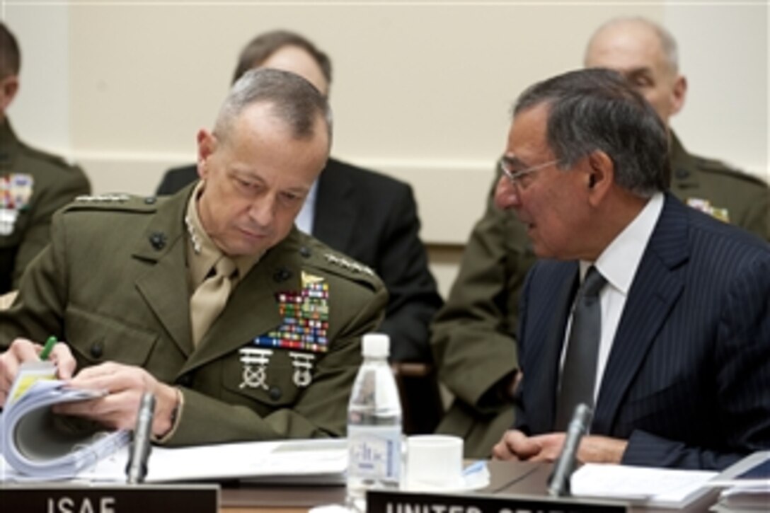 Secretary of Defense Leon E. Panetta speaks with Commander of the International Security Assistance Force Gen. John Allen, U.S. Marine Corps, at the meeting of NATO defense ministers in Brussels, Belgium, on Feb. 2, 2012.  