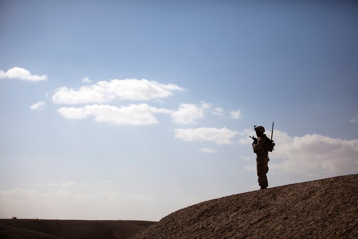 U.S. Marine Lance Cpl. Cody Varnell, a 20-year-old machine gunner with Combined Anti-Armor Team 2, Weapons Company, 3rd Battalion, 3rd Marine Regiment, and a native of Mesquite, Texas, holds security atop a hill while halted during a partnered security patrol with Afghan Border Police here, Jan. 30. In southern Garmsir district, an area with a history of tribal conflict, the growing ABP force has deepened its roots and established governance through the mentorship of the 3/3 Weapons Co. Marines. The ABP is younger and significantly smaller than the Afghan National Army and police forces, but its mission is vital as Afghan forces prepare to assume lead security responsibility in Garmsir. “If the ABP didn’t exist, there would be holes all along Afghanistan’s southern border,” said Capt. Jason Armas, 33, the commanding officer of Weapons Co., 3/3, and a native of Rye, N.Y.
