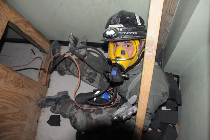 Making his way along a labyrinth of confining spaces at the Downey Responder Training Facility onboard the Naval Support Facility Indian Head Stump Neck Annex is Lance Cpl. Tyler Pope, a technical rescue Marine with CBIRF-IRF A. Pope participated in a joint 72 hour technical rescue training exercise with the U.S. Army 911th Technical Rescue Engineer Company Jan 10 - 12, 2012.