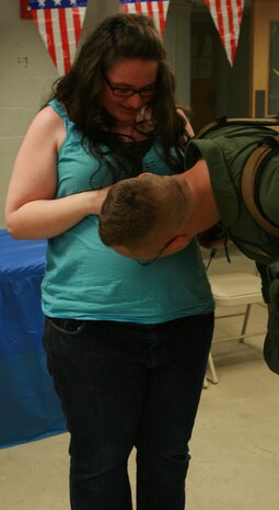 Cpl. Ian C. Schuelke, Initial Response Force A, Chemical Biological Incident Response Force, greats his wife and 'baby on the way' after returning home from a month long deployment in support of Operation Tomodachi. The Marines of IRF A Deployed to Japan after a catastrophic earthquake and soon after tsunami shook the country and critically damaging the nuclear power plant Fukushima Dai-ichi. 