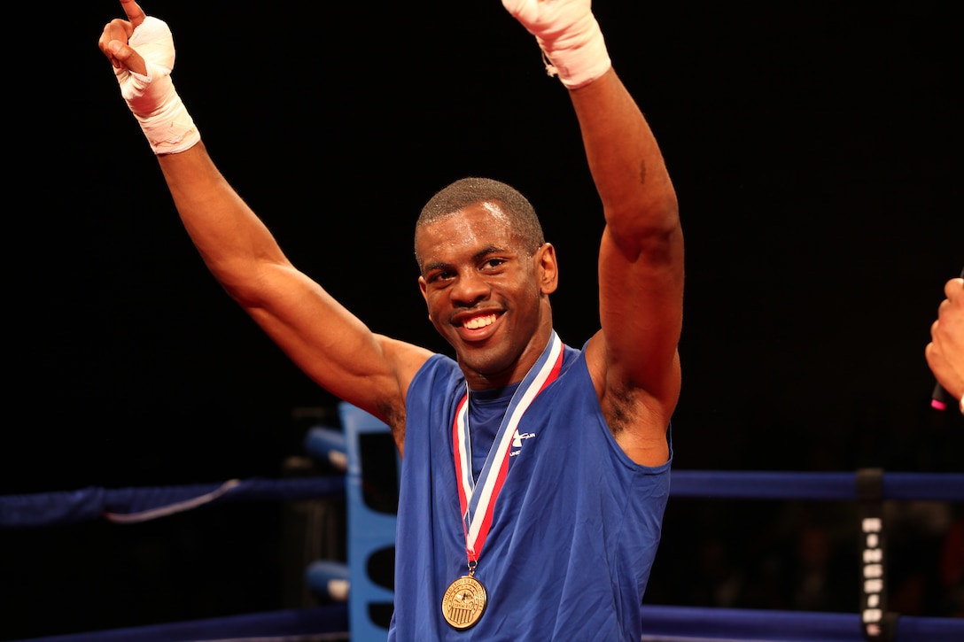 Sgt. Jamel Herring raises his hand with prestige after a well fought victory against his strenuous opponent Senior Airman Adan Hassan at the 2012 Armed Forces Boxing Championships at Paige Fieldhouse Feb. 3.::r::::n::