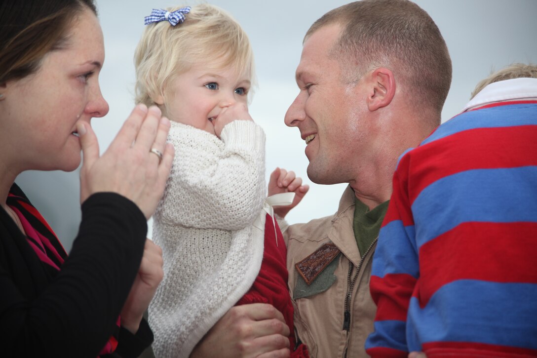 Navy Lt. Luke Quebedeaux, a physiologist with 2nd Marine Aircraft Wing (Forward), holds his 2-year-old daughter, Addison, and 4-year-old son, Sam, for the first time in seven months, during the Marine Aerial Refueler Transport Squadron 252 homecoming, at Marine Corps Air Station Cherry Point Feb. 2. Alison Quebedeaux, spouse of Luke’s spouse, said she couldn’t wait to tell her husband how much she loved him and how much she missed him while he was gone.