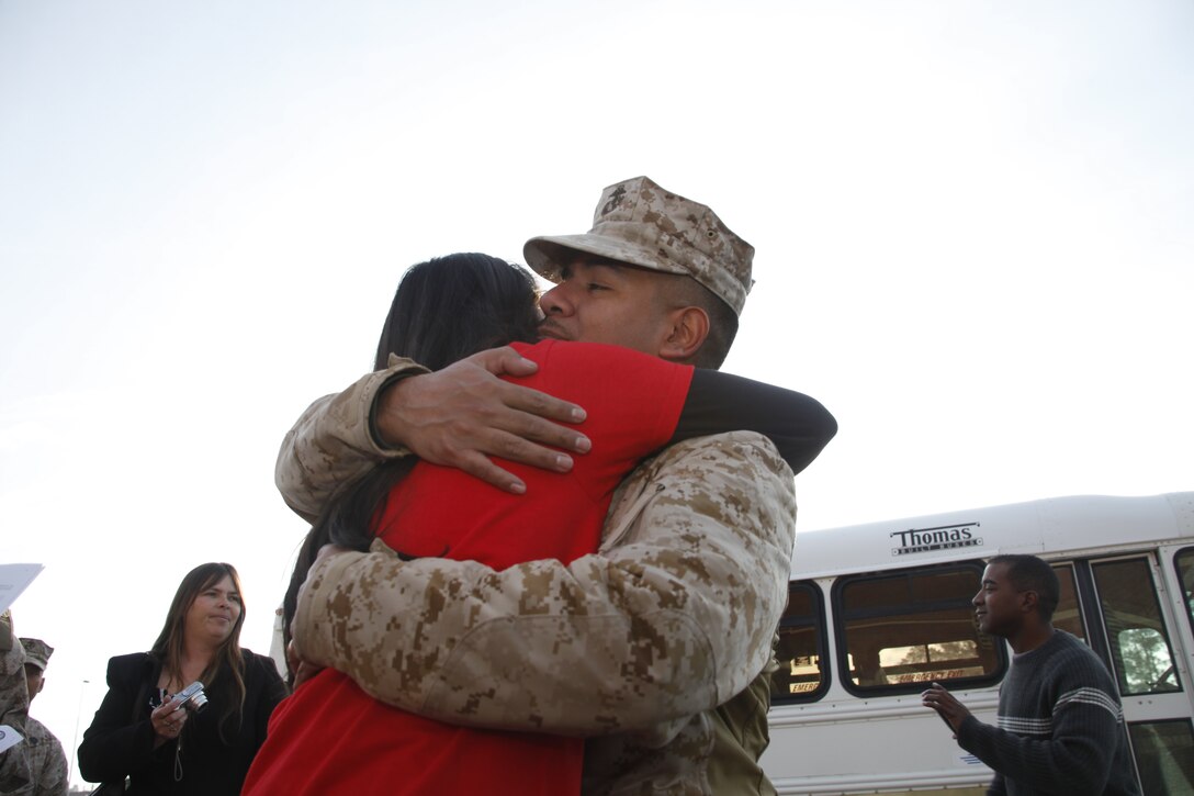 Staff Sgt. Alex Aguilar, an aviation information systems specialist with Marine Aviation Logistics Squadron 14, embraces his 13-year-old daughter, Brenda, outside of the Training and Education Building aboard Marine Corps Air Station Cherry Point Feb. 4, 2012, after returning from a deployment to Camp Bastion, Afghanistan. Brenda said that she was glad to finally have her father back home.