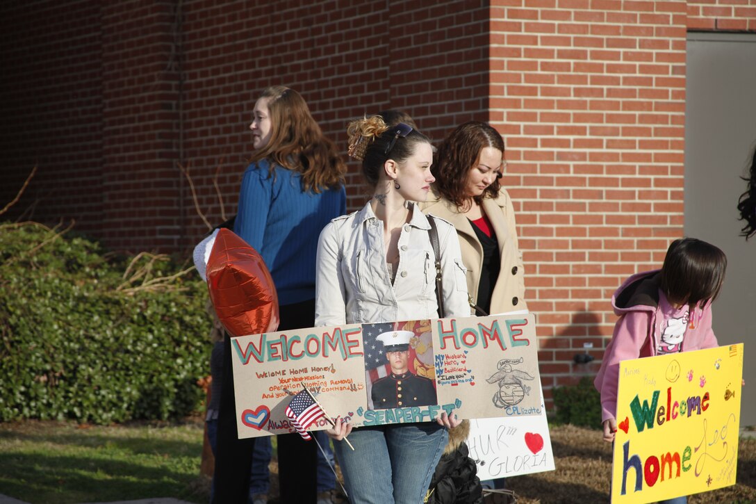 Nicole Lizotte holds a sign she made while she awaits for the arrival of her husband, Cpl. Richard Lizotte, in front of the Training and Education Building at Marine Corps Air Station Cherry Point Feb. 4, 2012. Richard, an aviation supply specialist with Marine Aviation Logistics Squadron 14, returned with other Marines from the squadron after a 7-month deployment to Camp Bastion, Afghanistan.