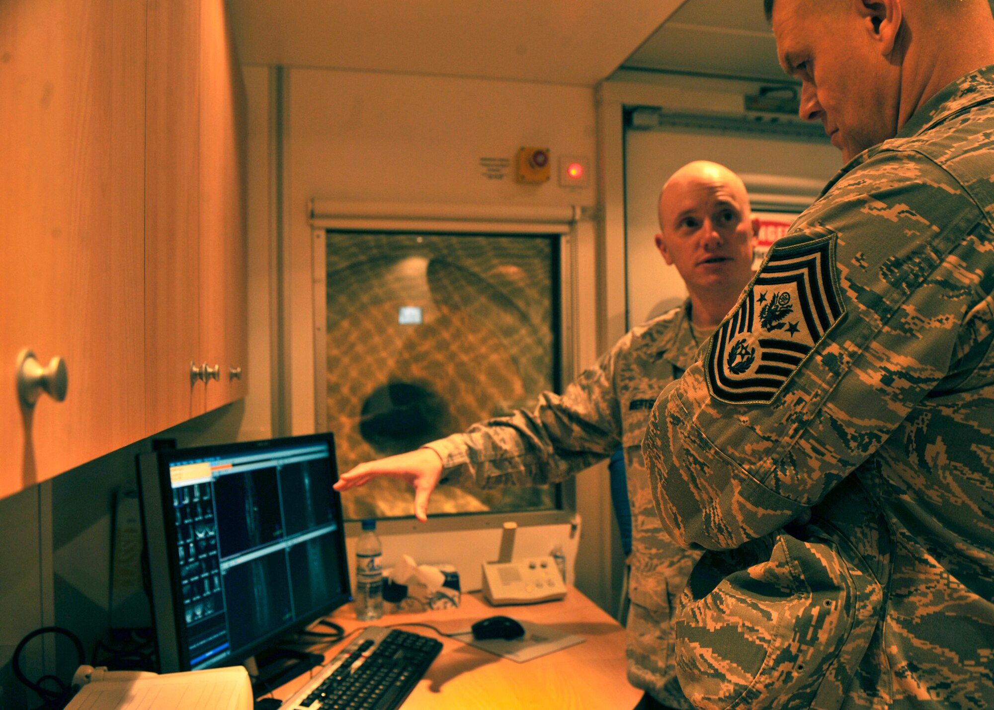 BAGRAM AIRFIELD, Afghanistan— Tech. Sgt. Kris Robertson demonstrates the use of a magnetic resonance imaging machine to Chief Master Sgt. of the Air Force James Roy at Bagram Airfield, Afghanistan, Feb. 2, 2012. Along with a tour of the Craig Joint Theater Hospital, Roy’s visit to Bagram included a tour of the Explosive Ordinance Disposal shop and a chance to speak to several different groups of Airmen. (U.S. Air Force photo/Airman 1st Class Ericka Engblom)