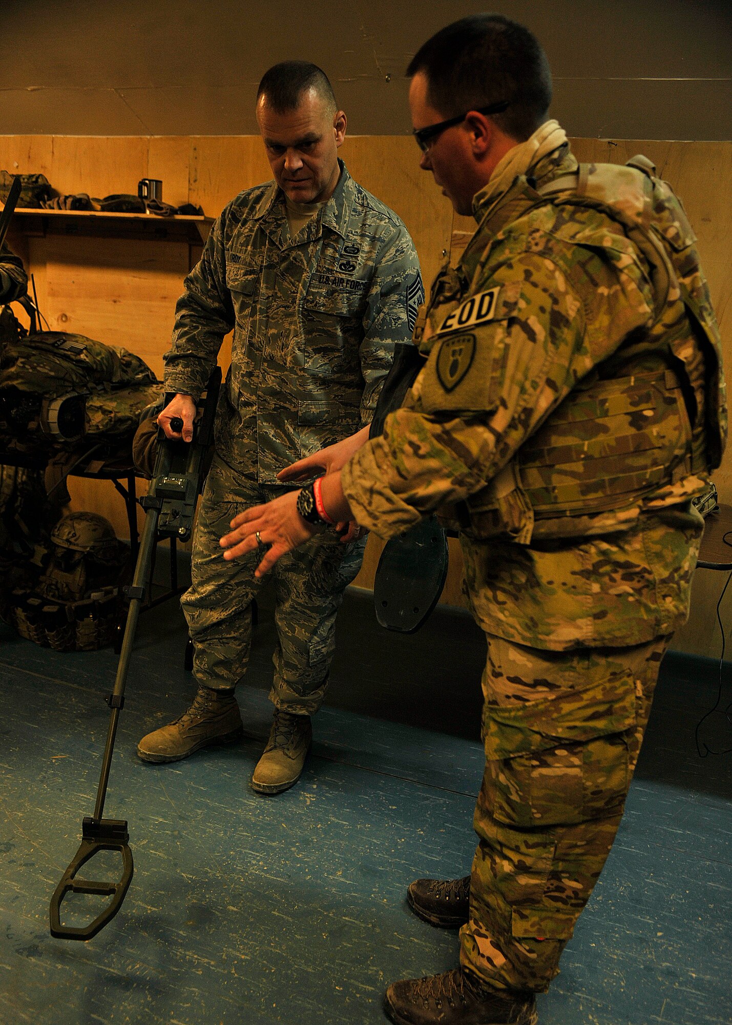 BAGRAM AIRFIELD, Afghanistan— Staff Sgt. Frank Green explains the piece of metal detecting equipment being handled by Chief Master Sgt. of the Air Force James Roy at Bagram Airfield, Afghanistan, Feb. 2, 2012. Green is an explosive ordinance disposal technician and was part of the team that demonstrated EOD’s deployed capabilities to the chief master sergeant of the Air Force. (U.S. Air Force photo/Airman 1st Class Ericka Engblom)