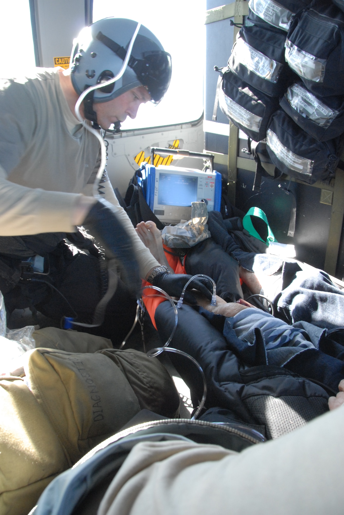 Master Sgt. Jimmy Petrolia and Staff Sgt. Adam Vanhaaster, pararescuemen assigned to the 131st Rescue Squadron, provide medical attention to a 54-year-old male patient suffering from stroke-like symptoms Feb. 4, 2012. Responding to the call from the Eleventh District Coast Guard at Alameda, pararescuers, or PJs, two HH-60G Pave Hawks and one MC-130P Combat Shadow aircraft departed Moffett Federal Airfield for the MSC Beijing, acargo ship more than 200 miles off the coast of California. Guardsmen air lifted the patient to the San Jose Regional Medical Center. (Air National Guard photo by Senior Airman Jessica Green)