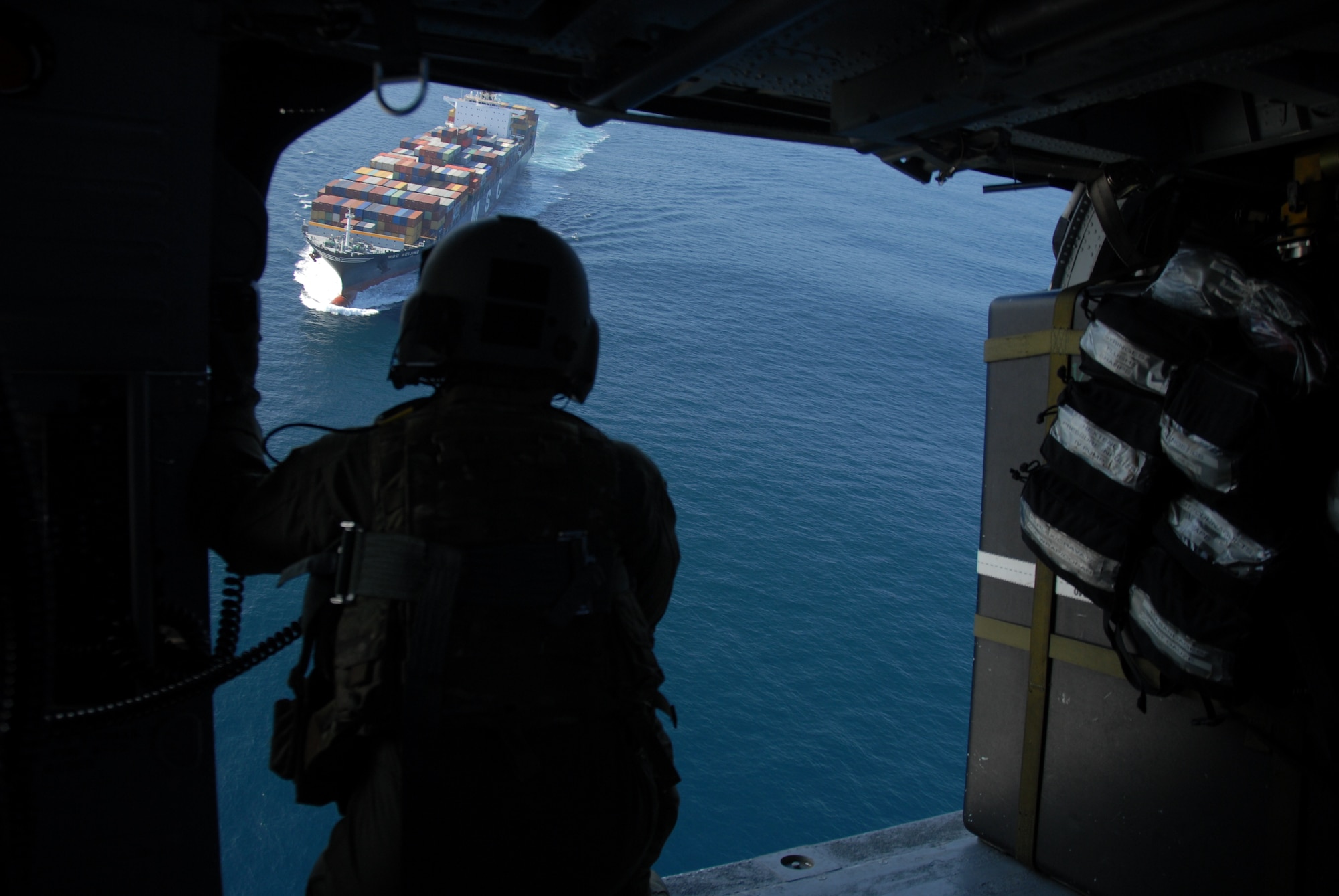 Staff Sgt. Michael Wang, an aerial gunner assigned to the 129th Rescue Squadron, watches for the pararescueman aboard MSC Beijing to signal for pick up Feb. 4, 2012. Responding to the call from the Eleventh District Coast Guard at Alameda, pararescuers, or PJs, two Pave Hawks and one MC-130P Combat Shadow aircraft departed Moffett Federal Airfield. The team provided medical assistance to a 54-year-old male who had suffered stroke-like symptoms on the cargo ship more than 200 miles off the coast of California. Guardsmen medically evacuated the patient to the San Jose Regional Medical Center. (Air National Guard photo by Senior Airman Jessica Green)