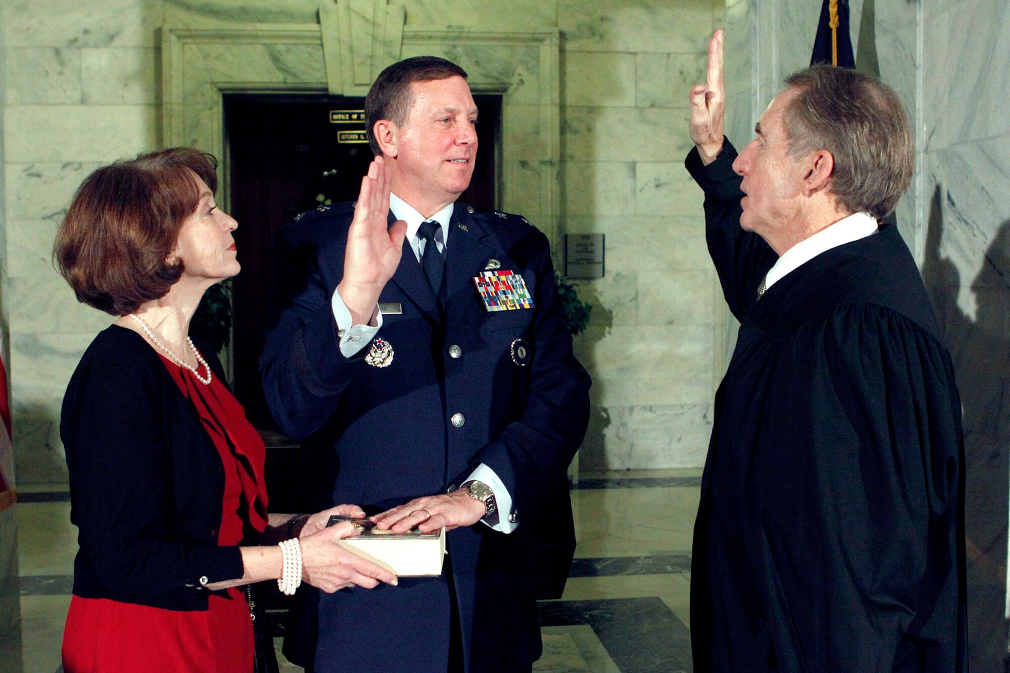 Kentucky Supreme Court Chief Justice John D. Minton Jr. swears in Maj. Gen. Edward W. Tonini for a second term as adjutant general of the Kentucky National Guard Dec. 13, 2011, while Tonini's wife, Carol, looks on. The ceremony was held in the Capitol rotunda in Frankfort, Ky., immediately following Gov. Steve Beshear's oath of office. (Courtesy photo)