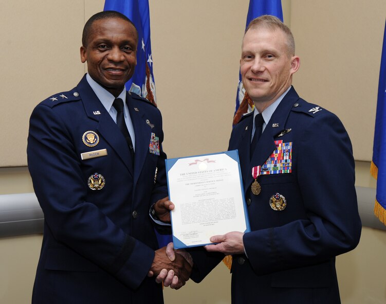 Air Force District of Washington Commander Maj. Gen. Darren W. McDew presents the Air Force Meritorious Service Medal to AFDW Chief of Safety Col. Steven C. Franklin, Feb. 2, at the first commander’s call held in the Jacob E. Smart Center, Joint Base Andrews, Md. In support of Operation Enduring Freedom, Franklin distinguished himself as the assistant deputy commander for the 9th Air and Space Expeditionary Task Force, Kabul, Afghanistan. (U.S. Air Force photo by Staff Sgt. Christopher Ruano)