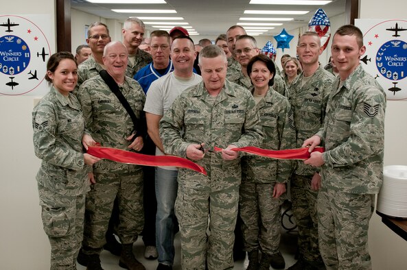 Chief Master Sgt. Curtis Carpenter, command chief of the 123rd Airlift Wing, cuts a ribbon officially reopening the Kentucky Air National Guard's Morale, Welfare and Recreation facility at the Louisville, Ky., base on Jan. 7, 2012. The facility, now known as The Winner's Circle, features pool and foosball tables, a kitchen and a volleyball court. It is operated by the 123rd Force Support Squadron. (U.S. Air Force photo by Senior Airman Maxwell Rechel)