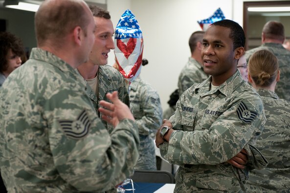 Tech. Sgt. Shuan Cowherd (right), assistant wing fitness manager for the 123rd Force Support Squadron, talks with fellow FSS Airmen Tech. Sgt. Ricky Odle (middle) and Tech. Sgt. Aaron Foote at the reopening of the Kentucky Air National Guard's Morale, Welfare and Recreation facility in Louisville, Ky., on Jan. 7, 2012. The facility, known as The Winner's Circle, features pool and foosball tables, a kitchen and a volleyball court. It is operated by the 123rd Force Support Squadron. (U.S. Air Force photo by Senior Airman Maxwell Rechel)