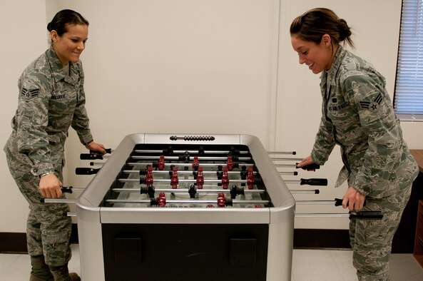 Senior Airman Jeannie Belgrave (left) and Senior Airman Ashley Nix, both food service specialists in the 123rd Force Support Squadron, play foosball at the reopening of the Kentucky Air National Guard's Morale, Welfare and Recreation facility in Louisville, Ky., on Jan. 7, 2012. The facility, now known as The Winner's Circle, also features a pool table, kitchen and volleyball court. It is operated by the 123rd Force Support Squadron. (U.S. Air Force photo by Senior Airman Maxwell Rechel)