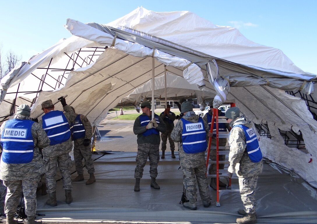 Army and Air Guard personnel work together to set up medical tents and receive simulated patients from a chemical decontamination line during a disaster-response exercise held Nov. 28, 2011, at the Wendell H. Ford Regional Training Center in Greenville, Ky. The troops are part of a CERFP - short for Chemical, biological, radiological, nuclear or high-yield explosive Enhanced Response Force Package - that provides immediate response capability to the governor of a state affected by a terrorist or enemy attack. (Courtesy photo)