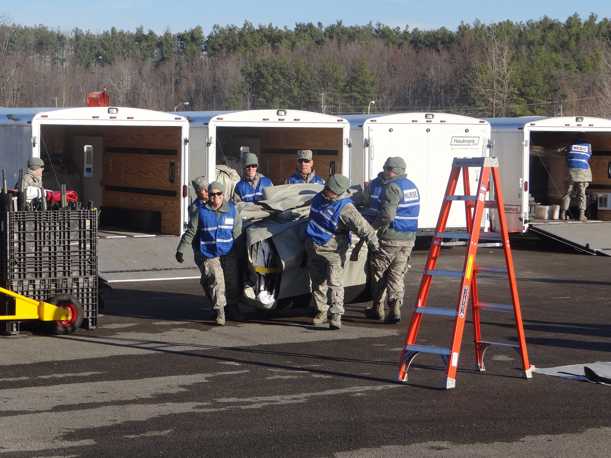Kentucky Air National Guard CERFP members unload tents and medical supplies from trailers at the Wendell H. Ford Regional Training Center in Greenville, Ky., during a disaster-response exercise Nov. 28, 2011. CERFP - short for Chemical, biological, radiological, nuclear or high-yield explosive Enhanced Response Force Package - provides immediate response capability to the governor of a state affected by an attack, searching an incident site, rescuing and decontaminating casualties, and performing medical treatment to stabilize them for transport to a medical facility. (Courtesy photo)