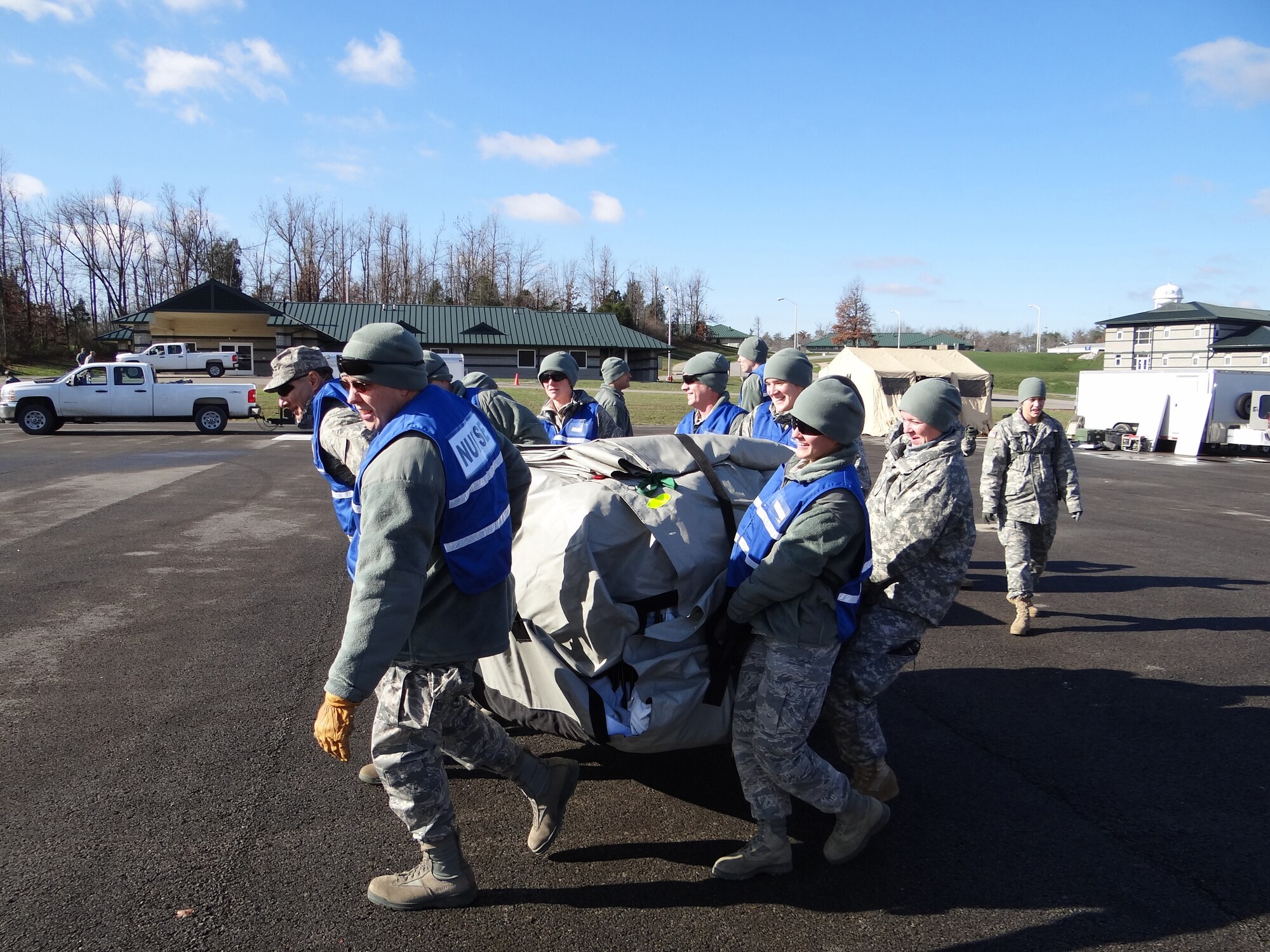 Lt. Col. David Worley (left), chief nurse of the Kentucky Air National Guard's 123rd Medical Group, leads CERFP Airmen as they position medical tents at the Wendell H. Ford Regional Training Center on Nov. 28, 2011. The CERFP is capable of  searching an incident site, rescuing and decontaminating casualties, and performing medical treatment to stabilize patients for transport to a medical facility. (Courtesy photo)