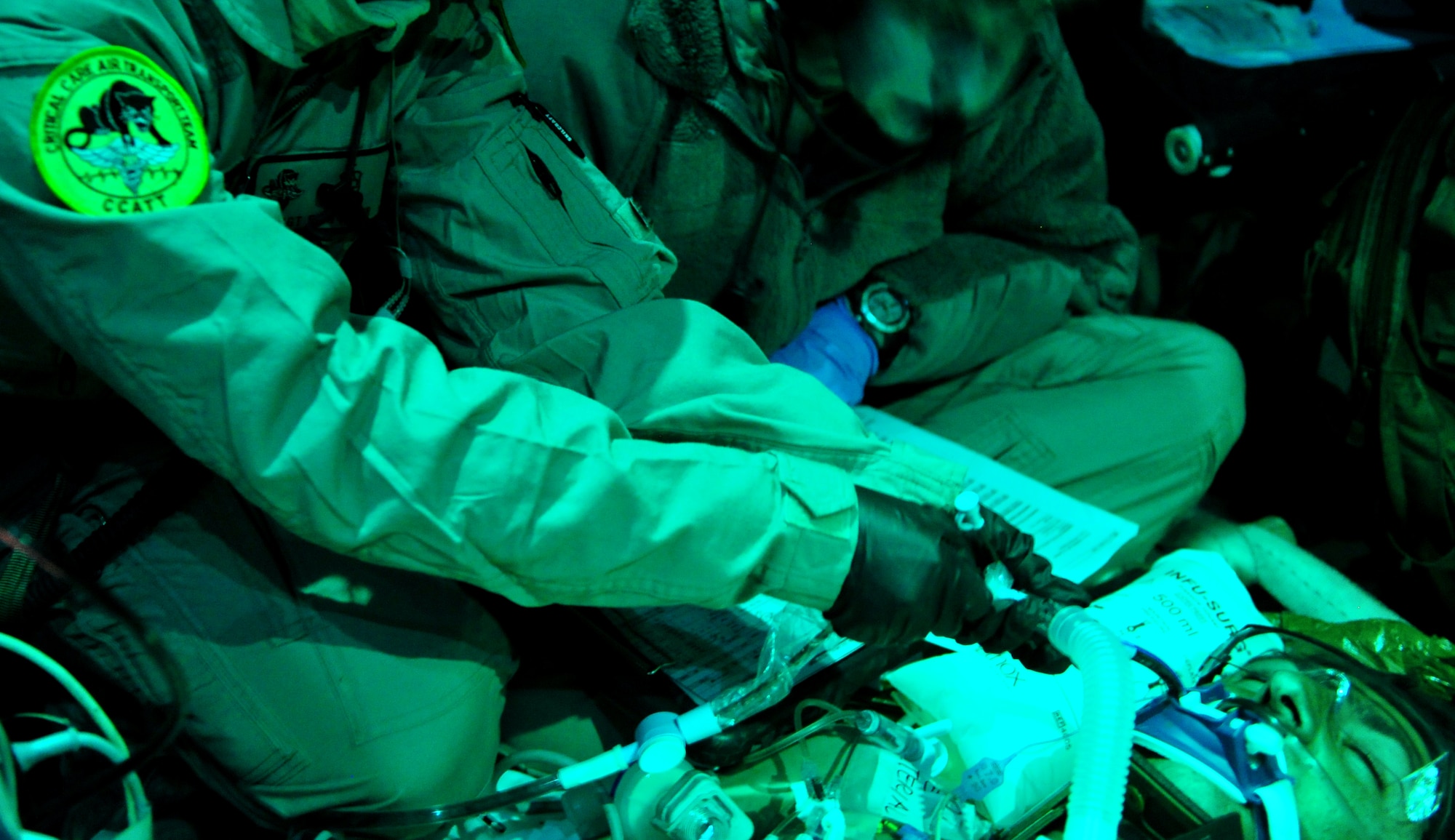 CAMP BASTION, Afghanistan -- A member of the 76th Expeditionary Rescue Squadron Critical Care Air Transport team provides care to a patient onboard a flight to a higher care medical facility. The teams are the first all-Air Force CCAT and AE teams to fly with the only fixed wing aircraft dedicated to medical evacuation missions in Afghanistan. (U.S. Air Force photo/Senior Airman Tyler Placie)