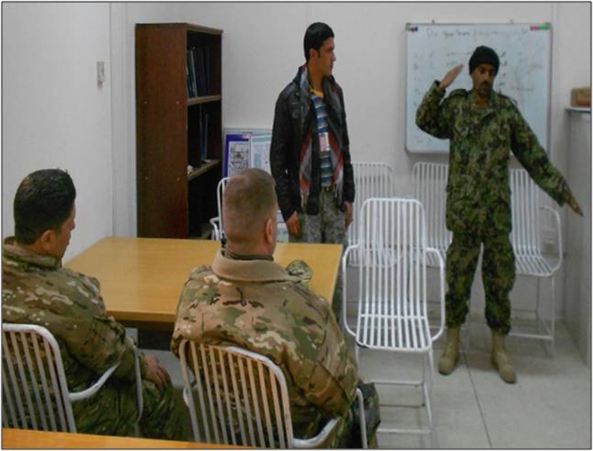 Afghan air force Sgt. Mohammad Dawood teaches U.S. Air Force airfield management advisors the importance of safety during an aircraft marshalling course at Shindand Air Base, Afghanistan, Feb. 1, 2012. Normally the class is taught by U.S. advisors to their replacements and Afghan maintenance personnel. This marked the first time AAF maintainers have taught a class to U.S. or Coalition members. (U.S. Air Force courtesy photo)