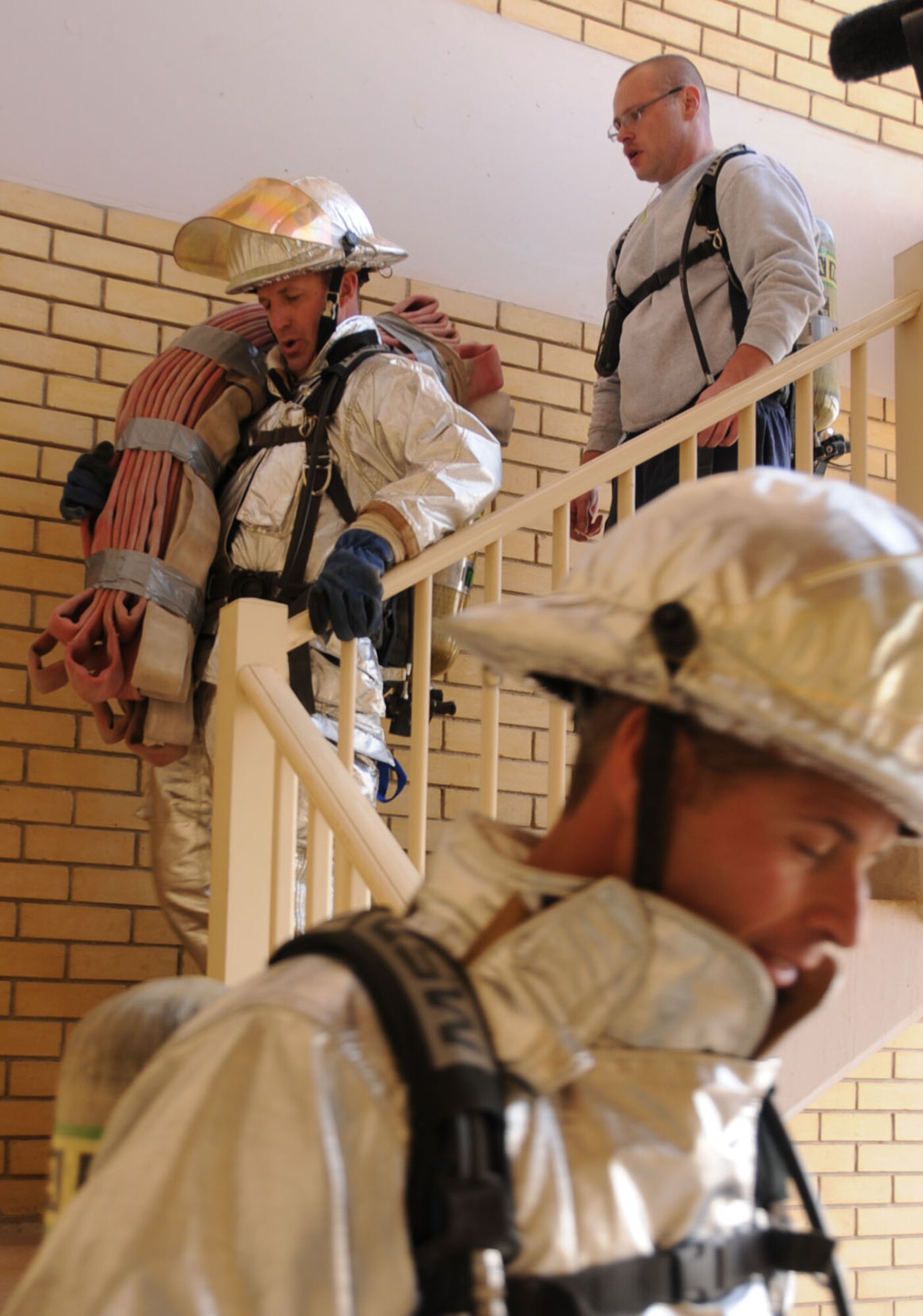 U.S. Air Force Lt. Col. John Franklin (middle), 386th Expeditionary Maintenance Group deputy commander, descends down stairs in an undisclosed location in Southwest Asia Feb. 3, 2012. Franklin and firefighters from the 386th Expeditionary Civil Engineering Squadron participated in a 1,280-stair climbing charity event for the Cystic Fibrosis Foundation’s ‘Climb for a Cure’ in Minneapolis, Minn.;  Franklin has a 7-year-old daughter, Anna, who is diagnosed with CF. (U.S. Air Force photo by Staff Sgt. James Lieth/Released)
