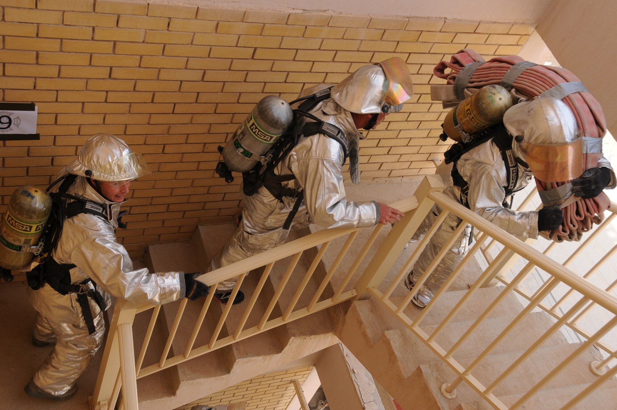 U.S. Air Force firefighters from the 386th Expeditionary Civil Engineering Squadron climb up stairs in an undisclosed location in Southwest Asia Feb. 3, 2012. Members of the 386th ECES participated in a 1,280-stair climbing charity event for the Cystic Fibrosis Foundation’s ‘Climb for a Cure’ in Minneapolis, Minn. (U.S. Air Force photo by Staff Sgt. James Lieth/Released)