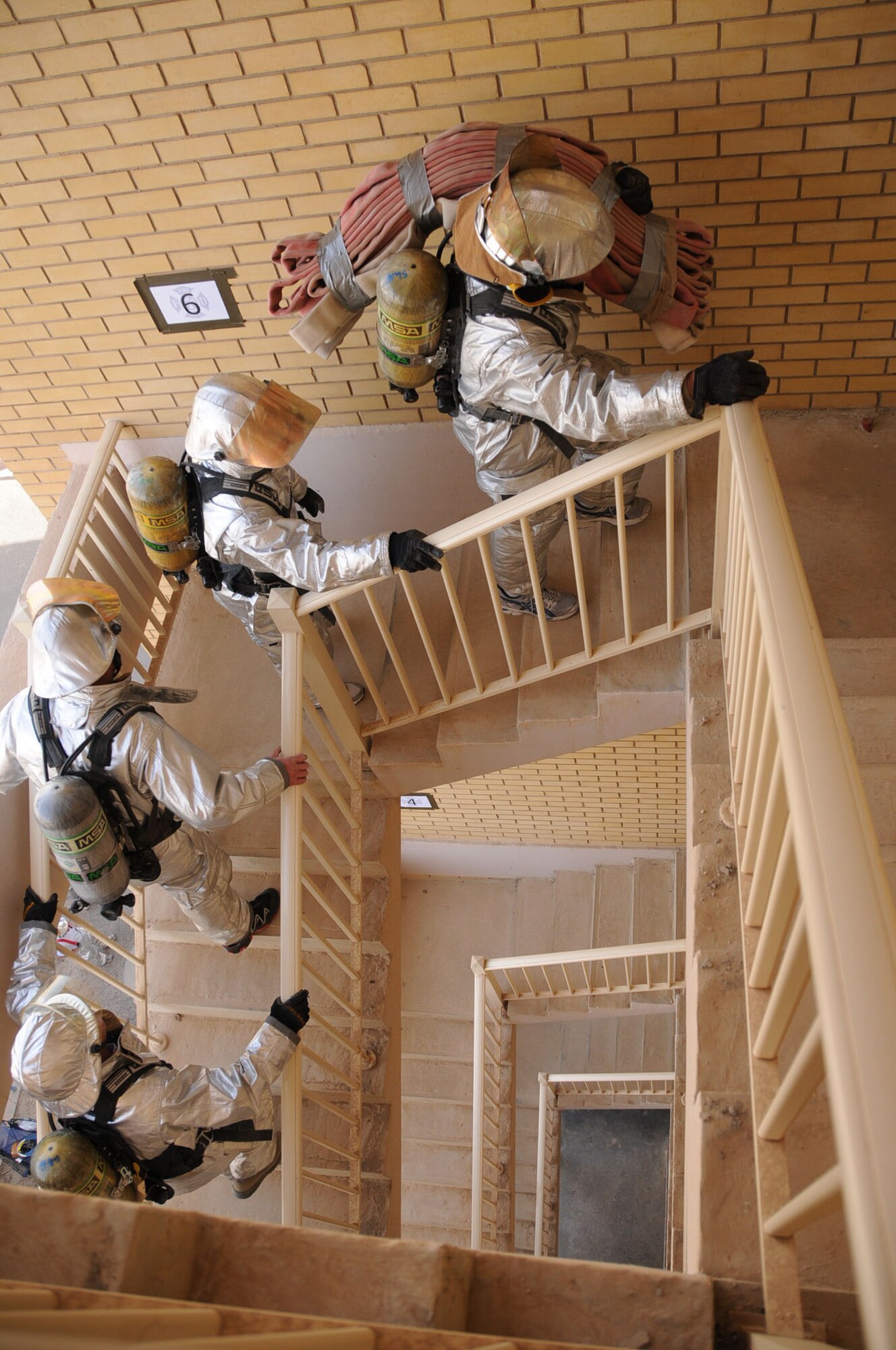 U.S. Air Force firefighters from the 386th Expeditionary Civil Engineering Squadron climb up stairs in an undisclosed location, Southwest Asia Feb. 3, 2012. Members of the unit participated in a 1,280-stair climbing charity event for the Cystic Fibrosis Foundation?s ?Climb for a Cure? in Minneapolis, Minn., in conjunction with a fellow fire department in St. Paul, Minn. (U.S. Air Force photo by Staff Sgt. James Lieth/Released)