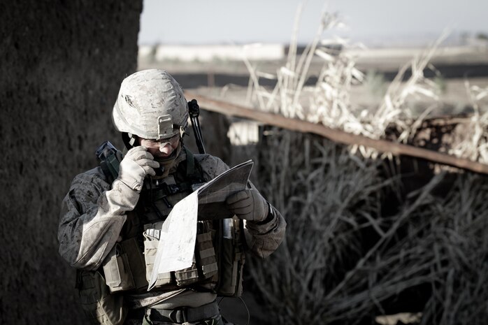 1st Lt. Matt T. Perry, 2nd Platoon commander, Weapons Co., 3rd Battalion, 7th Marine Regiment, reports back to headquarters during a two-day operation here, recently. Perry, a native of Slidell, La., and 2008 graduate of Louisiana State University, led a squad of Afghans and Marines. They secured their first objective after interacting with the residents and searching compounds for illegal activity.