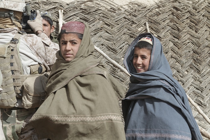 Afghan children wait to be documented during a two-day operation here, recently. Afghan National Army soldiers from 4th Tolai, 2nd Kandak, 2nd Brigade, 215th Corps, and Marines from Weapons Co., 3rd Battalion, 7th Marine Regiment, searched the area for insurgent activity.