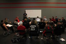 CrossFit instructor Tyler Quinn discusses principles of nutrition, coaching techniques and the psychology of CrossFit with a group of Marines Feb. 5. More than 20 recruiters and command group members with Recruiting Station Twin Cities attended the three-day training seminar to enhance fitness levels within the command. For additional imagery from the event, visit www.facebook.com/rstwincities.