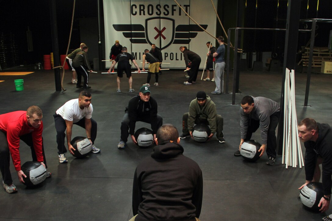 Bloomington, Minn., recruiter Sgt. Julio C. Gonzalez leads Marines with Recruiting Station Twin Cities in a group exercise at CrossFit Minneapolis Feb. 5. More than a dozen recruiters attended the three-day CrossFit training seminar to enhance fitness levels within the Delayed Entry Program. For additional imagery from the event, visit www.facebook.com/rstwincities.