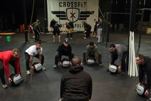 Bloomington, Minn., recruiter Sgt. Julio C. Gonzalez leads Marines with Recruiting Station Twin Cities in a group exercise at CrossFit Minneapolis Feb. 5. More than a dozen recruiters attended the three-day CrossFit training seminar to enhance fitness levels within the Delayed Entry Program. For additional imagery from the event, visit www.facebook.com/rstwincities.