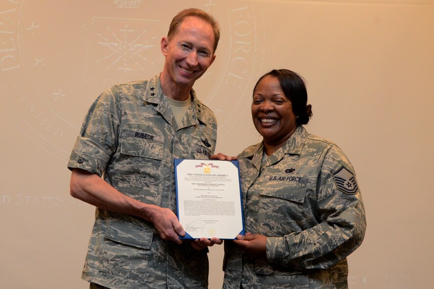 Maj. Gen. James T. Rubeor, special assistant to the commander, North American Aerospace Defense Command and United States Northern Command for Reserve Matters, Headquarters United States Northern Command, Peterson Air Force Base, Colo., presents the Meritorious Service Medal and Certificate to Master Sgt. Rosalyn L. Williams, 22nd Air Force Tasker Division superintendant, during her retirement ceremony Feb. 4, for 30 years of service to the U.S. Air Force and Air Force Reserve. (U.S. Air Force photo/Master Sgt. James Branch)
