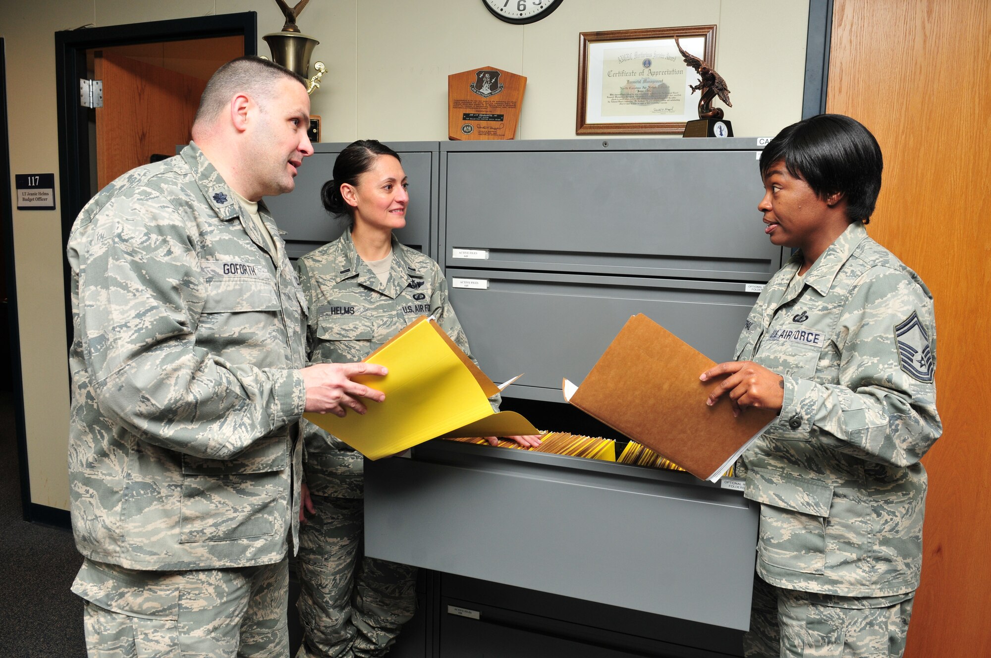Lt. Col. Gregory Goforth discusses accounting files with fellow 2011 NGB award winners from the 145 Comptroller Flight, (l-r) 1st Lt. Jeanie Helms and Senior Master Sgt. Latonya McPhail.  Lt. Col. Goforth was recognized as National Guard’s Financial Management Comptroller of the Year, while Lt. Helms received the Guard Bureau award for Financial Management Company Grade Officer and Senior Master Sgt. McPhail copped the Financial Management Superintendent of the year award. Photo by Tech. Sgt. Rich Kerner.