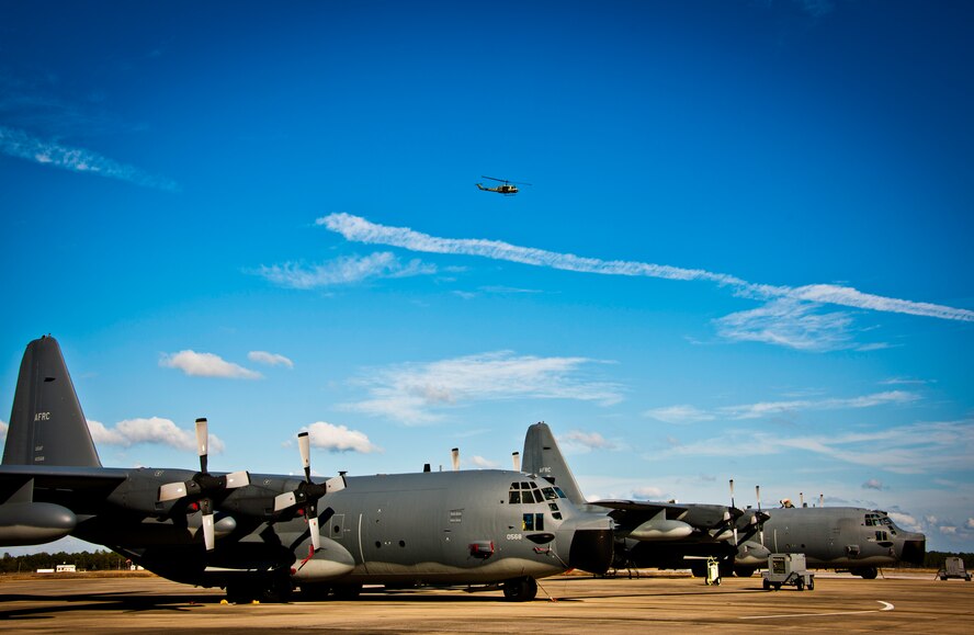 A UH-1 passes over the MC-130E Combat Talon Is of the 919th Special Operations Wing at Duke Field, Fla.  Currently, the 919th SOW has nine Talons on its flightline.  Four of Duke’s Talons are scheduled to retire by fiscal year 2012 as part of the wing’s remissioning.  (U.S. Air Force photo/Tech. Sgt. Samuel King Jr.)